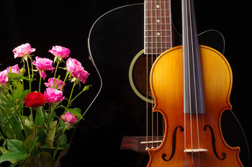 Fototapeta na wymiar Violin, guitar and roses on black