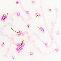 Plakat Pattern made of pink hyacinth petals and pastel shabby tapes on white background. Flat lay, top view.