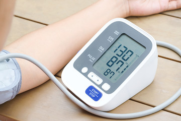 Human check blood pressure monitor and heart rate monitor with digital pressure gauge. Health care and  Medical concept