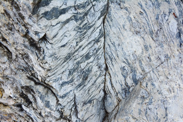 The texture of old stone wall. It is a beautifull natural patterned surface with white and gray