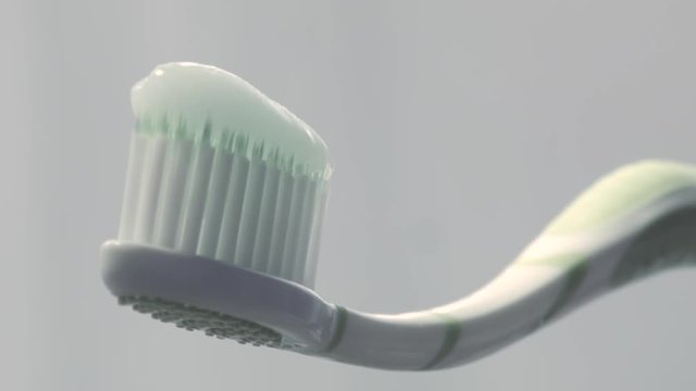 Toothbrush and toothpaste on white background. Detail shot.