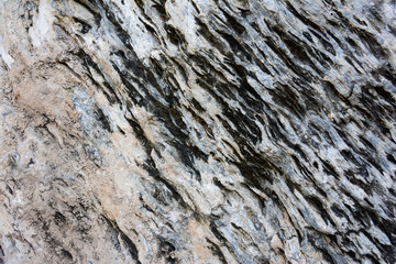 The texture of old stone wall. It is a beautifull natural patterned surface with white and gray