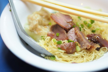 Egg noodles served “dry” with red roast pork