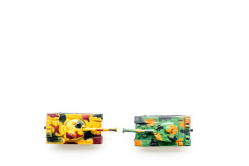 War concept. Tanks toy on white background top view copy space