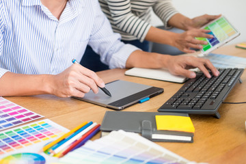 designer graphic creative creativity working together coloring using graphics tablet and a stylus...