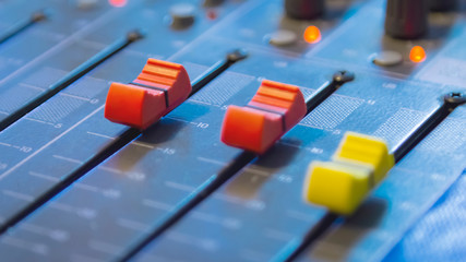 Slide the button to adjust the volume mixer of audio professionals. In the studio recording.