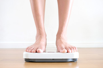 Legs of men standing on scales weight. Concept of health and weight loss.