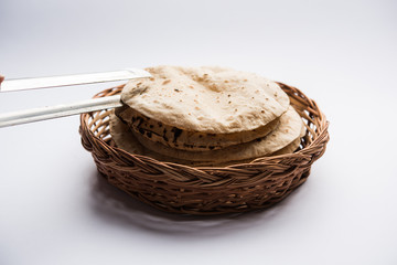 Obraz premium Chapati / Tava Roti also known as Indian bread or Fulka/phulka. Main ingredient of lunch/dinner in India/Pakistan. selective focus