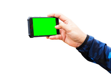 Men's hands are holding a mobile phone and green screen on white background