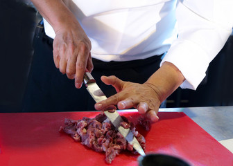 Butcher cutting pork meat, Chef cutting fresh raw meat, Chef cooking food in the kitchen