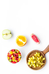 Obraz na płótnie Canvas Healthy diet concept. Fruit salad near fresh fruits on white background top view space for text