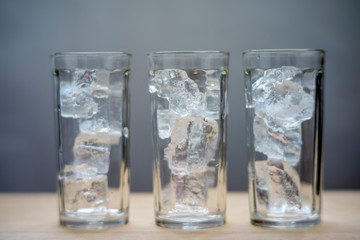 glass of ice on black background