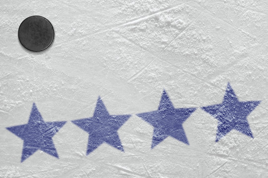 The image of dark blue stars on ice and hockey puck