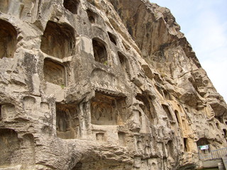 Fototapeta premium Luoyang Longmen grottoes. Broken Buddha and the stone caves and sculptures in the Longmen Grottoes in Luoyang, China. Taken in 14th October 2018