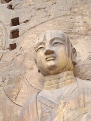 Obraz premium Luoyang Longmen grottoes. Broken Buddha and the stone caves and sculptures in the Longmen Grottoes in Luoyang, China. Taken in 14th October 2018