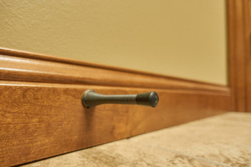 Isolated door stop spring mounted on trim