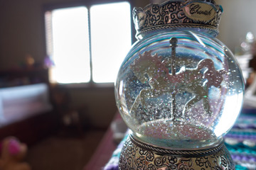 Snow globe with horse carousel
