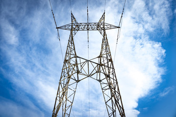 Electricity pole with a blue sky on background. Electricity pylon.