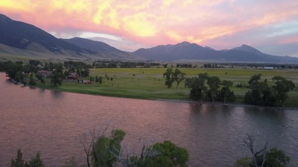 Aerial shot flying over the beautiful Yellowstone River in Paradise Valley at sunset in Montana