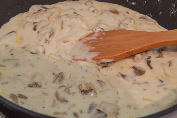  Cooking beef stroganoff in a pan.  Fresh veal, cooked at home.