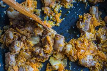 Food preparation. Cooking pork on the pan. Fried pork with onion  and carrot. Fresh fried pork prepared at home.