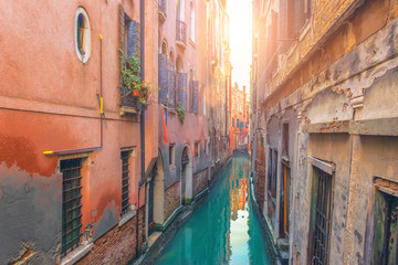 Fototapeta na wymiar Very narrow street and canal in Venice.
