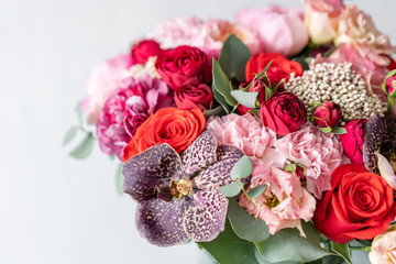 beautiful fresh cut bouquet of mixed flowers in vase on wooden table. . the work of the florist at a flower shop. Delicate Pastel tones color