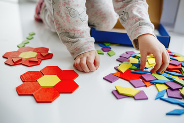 One little kids play with puzzle or tangram, education - Powered by Adobe