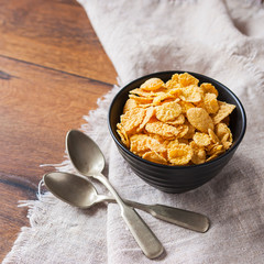 Сornflakes on wooden table at morning. The concept of diet, proper nutrition and a healthy lifestyle. Selective focus.