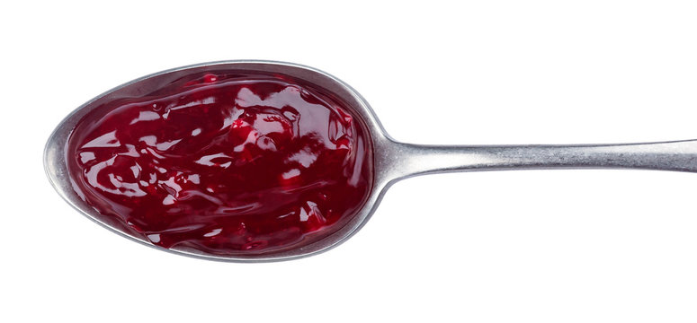 Spoon of red jam isolated on white background, top view