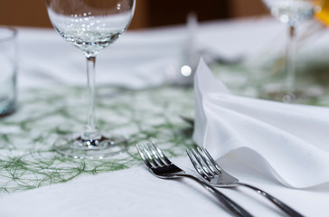 Decorated table on a gala dinner party with wine glasses and blurred out background