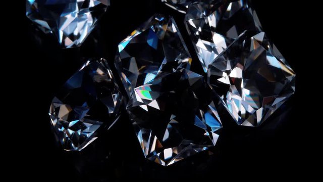 Gemstones rotate on a stand on a black background. Close up.