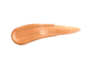 Light beige makeup smear of creamy foundation isolated on white background. Light beige creamy foundation texture isolated on white background