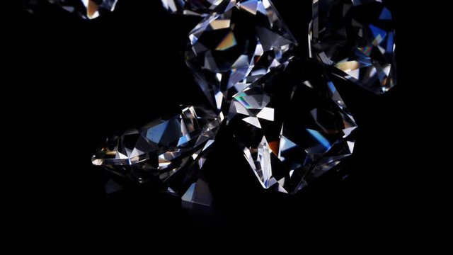 Gemstones rotate on a stand on a black background. Close up.