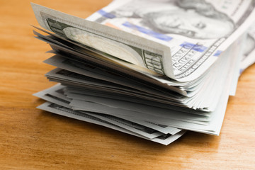 Close-up american dollar banknotes on wooden table.