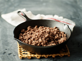 browned ground beef in cast iron skillet