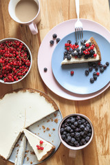 Slice of cheesecake with red currant and blackberries