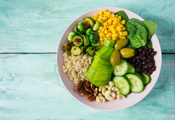 budha bowl with brussel cabbage, corn, quinoa, cucumbers,nuts, avocado and spinach