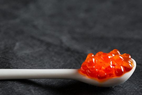 Red salted caviar on a spoon