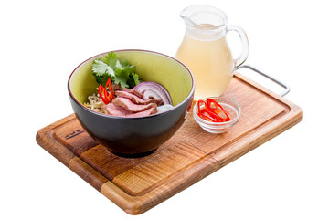 Spicy Asian soup with veal on a wooden Board. On white background.
