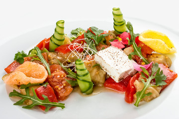 Bright vegetable salad with tofu and rice chips.