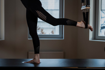 the girl is engaged in the simulator Pilates.