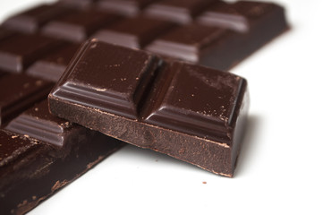closeup of milk chocolate blocks on white background
