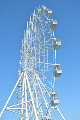 attraction ferris wheel on blue sky background