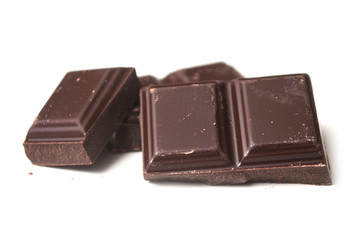 closeup of milk chocolate blocks on white background