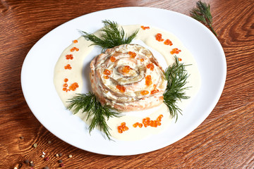 salmon in cream sauce decorated with red caviar and dill