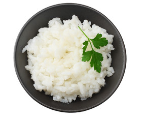 White rice in black bowl isolated on white background. top view
