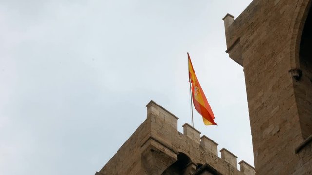 Spanish flag waving on the Torres de Quart, gateway to the medieval Christian wall of Valencia