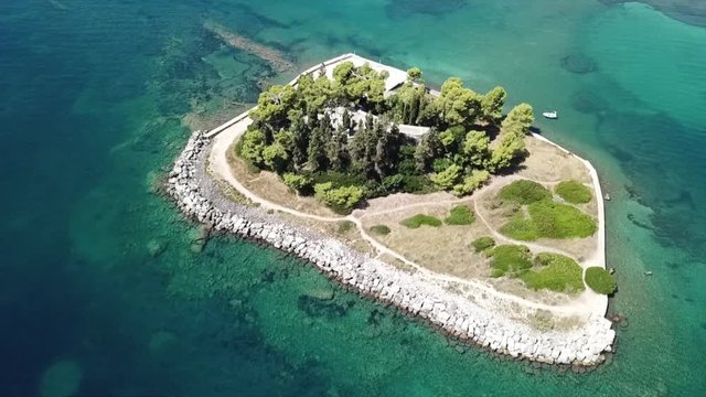 Aerial drone bird's eye view video of iconic small island of Pontikonisi or Mouse island in area of Kanoni, Corfu island, Ionian, Greece