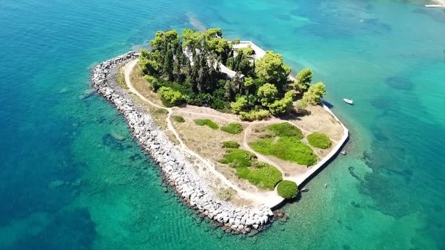 Aerial drone bird's eye view video of iconic small island of Pontikonisi or Mouse island in area of Kanoni, Corfu island, Ionian, Greece